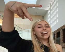 She has a small butterfly tattoo on her finger and one on her hand.